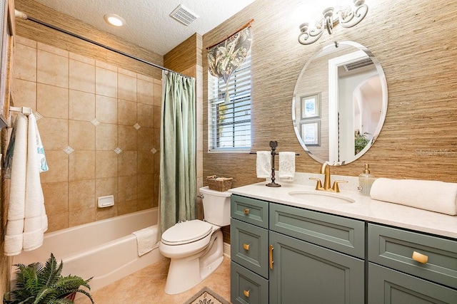 bathroom with visible vents, toilet, vanity, tile patterned floors, and a textured ceiling