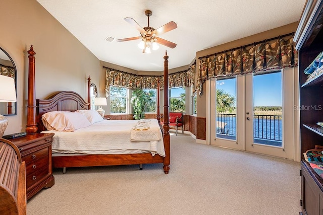 bedroom with ceiling fan, access to exterior, french doors, and light carpet