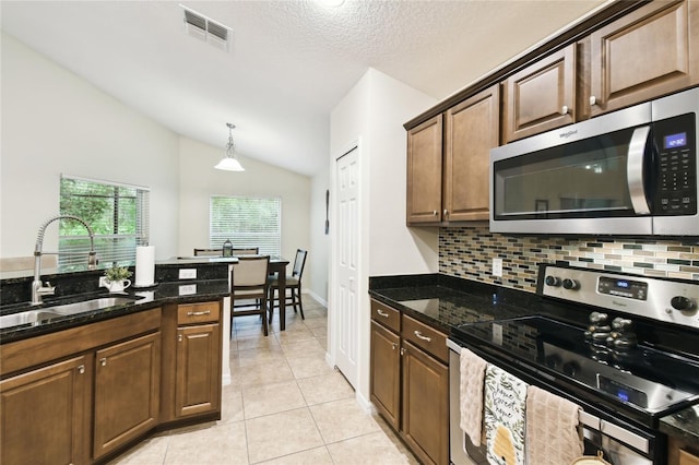 kitchen with tasteful backsplash, visible vents, light tile patterned floors, appliances with stainless steel finishes, and a sink