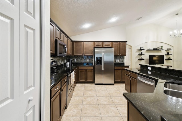 kitchen with light tile patterned flooring, dark brown cabinetry, stainless steel appliances, and lofted ceiling