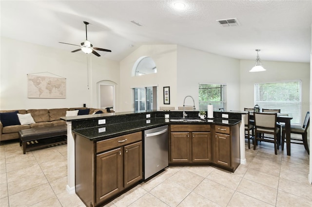 kitchen with light tile patterned floors, visible vents, a sink, dishwasher, and open floor plan