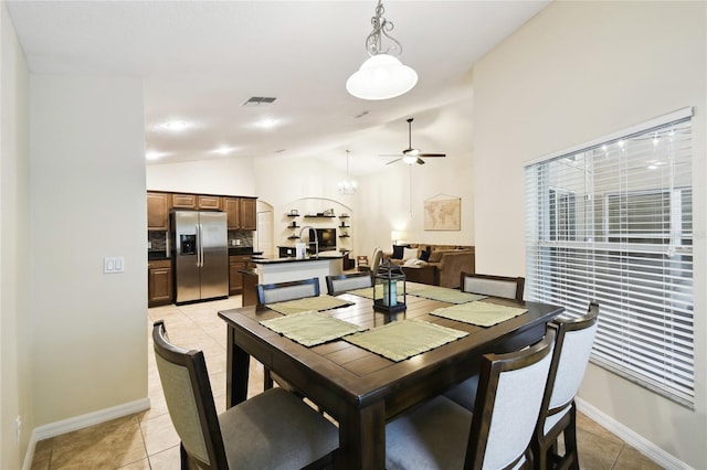 dining area featuring lofted ceiling, light tile patterned floors, a ceiling fan, and visible vents