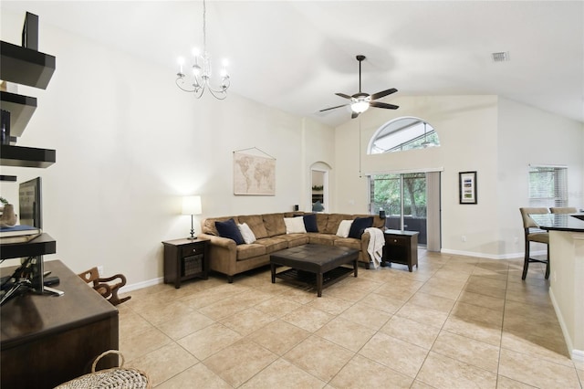 living room featuring visible vents, light tile patterned floors, ceiling fan with notable chandelier, arched walkways, and high vaulted ceiling