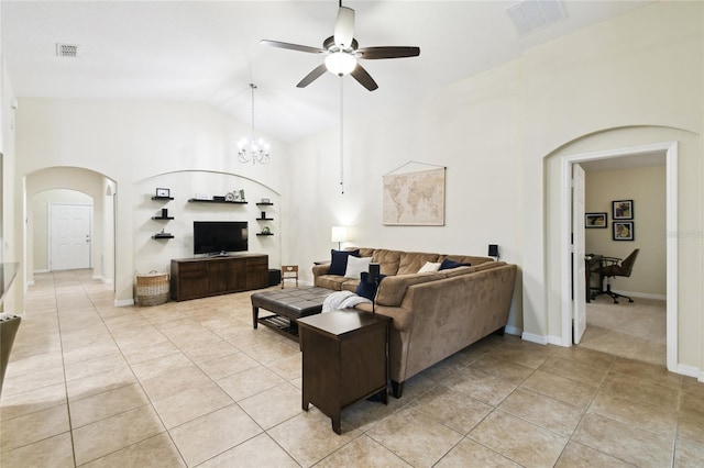 living area featuring light tile patterned floors, visible vents, arched walkways, and ceiling fan with notable chandelier