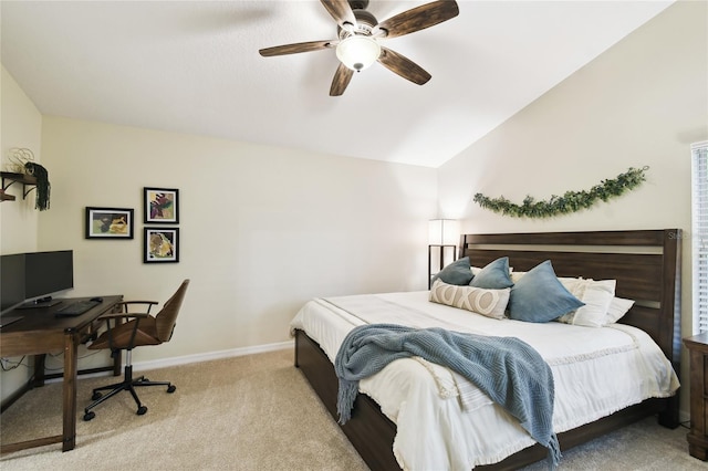 bedroom featuring light colored carpet, baseboards, lofted ceiling, and ceiling fan