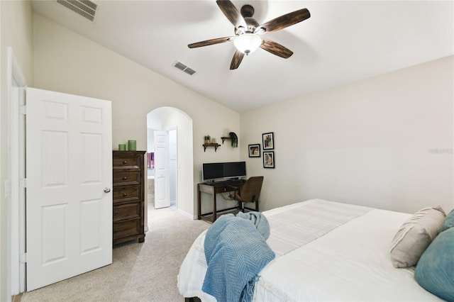 bedroom with visible vents, arched walkways, light colored carpet, and ceiling fan