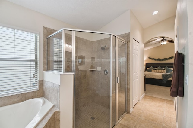 full bathroom with a ceiling fan, ensuite bathroom, a shower stall, tile patterned flooring, and a bath