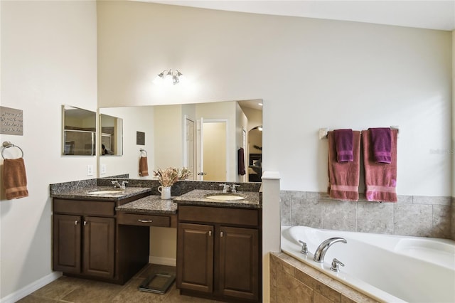 full bathroom with a bath, a sink, tile patterned floors, and double vanity