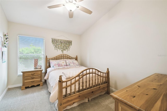 bedroom featuring vaulted ceiling, baseboards, and light carpet