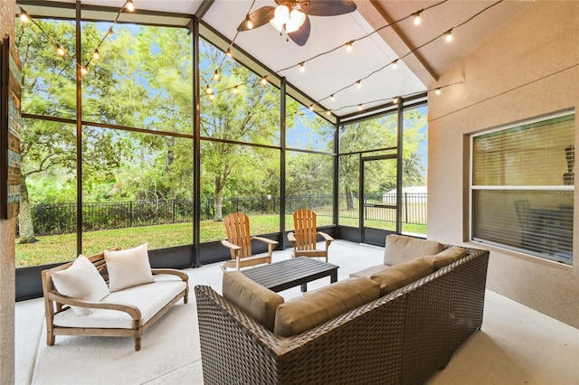 sunroom featuring rail lighting and ceiling fan