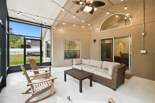 view of patio featuring a ceiling fan, a lanai, fence, and an outdoor hangout area