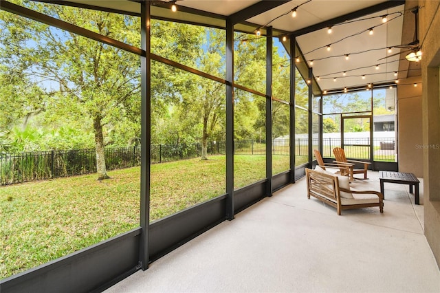 sunroom / solarium with rail lighting and ceiling fan