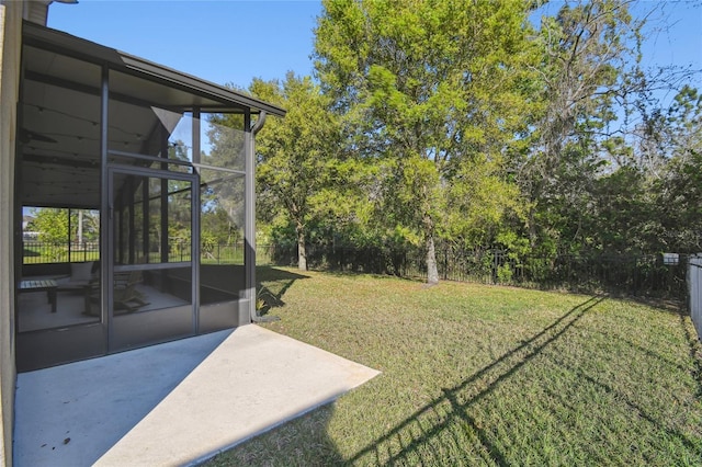 view of yard featuring a patio, a fenced backyard, and a sunroom