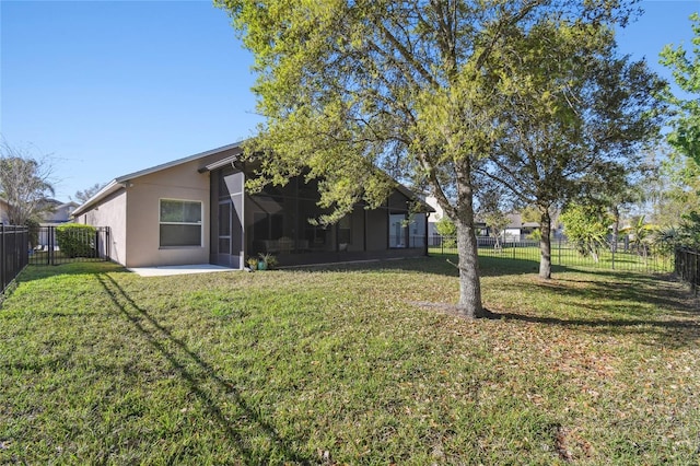 view of yard with a fenced backyard and a sunroom