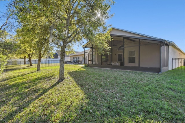 view of yard featuring a sunroom and fence