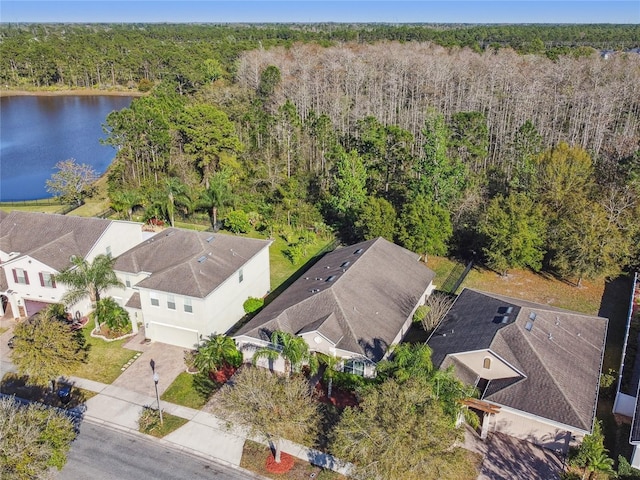 drone / aerial view featuring a view of trees and a water view