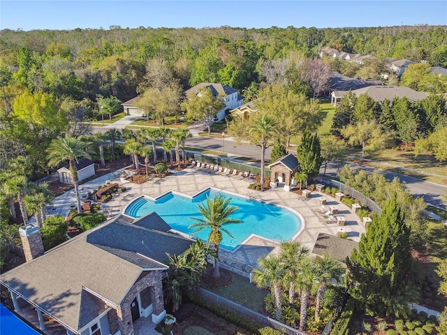 bird's eye view with a wooded view