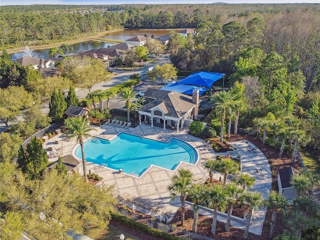 birds eye view of property with a water view and a view of trees