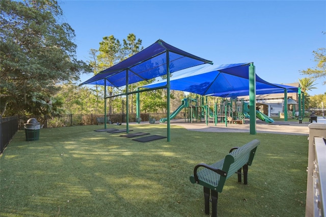 communal playground with a lawn and fence