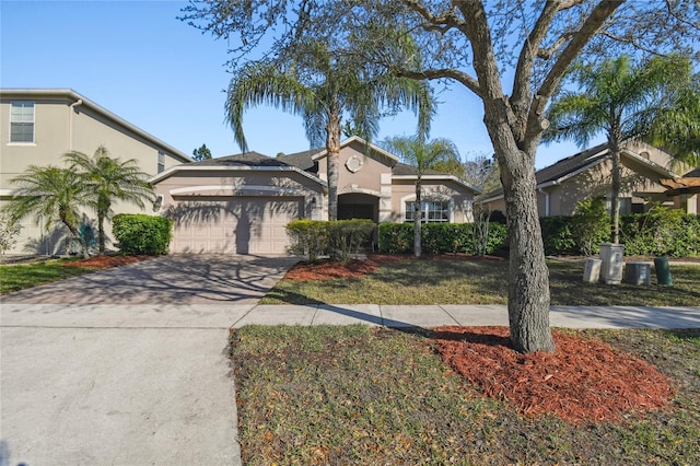 mediterranean / spanish-style home with a garage, driveway, and stucco siding