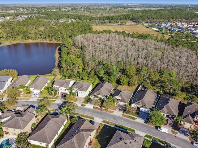 birds eye view of property featuring a residential view, a view of trees, and a water view