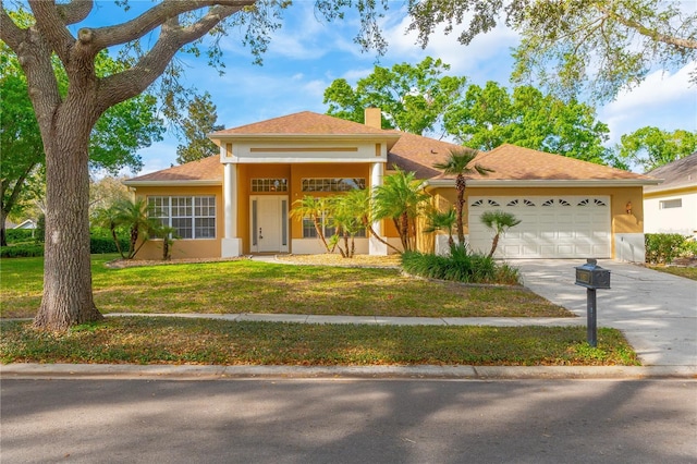 view of front of house featuring a chimney, stucco siding, concrete driveway, a front lawn, and a garage