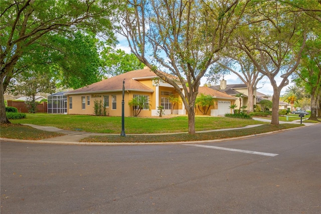 view of front of property with a garage, a front yard, and stucco siding