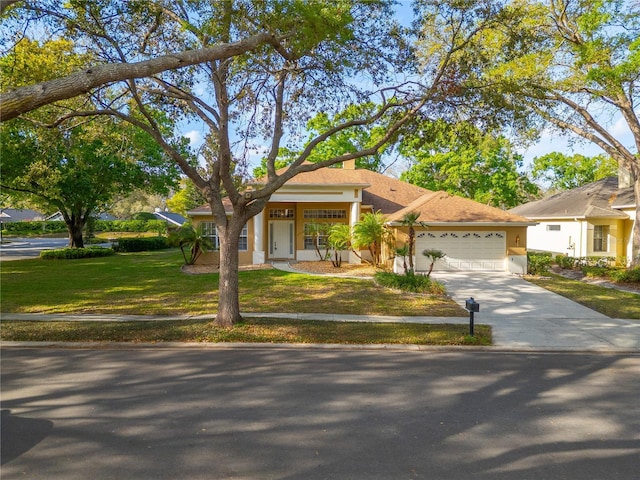 1187 Tadsworth Ter, Lake Mary, FL 32746 - view of front of property with a front yard, an attached garage, driveway, and stucco siding