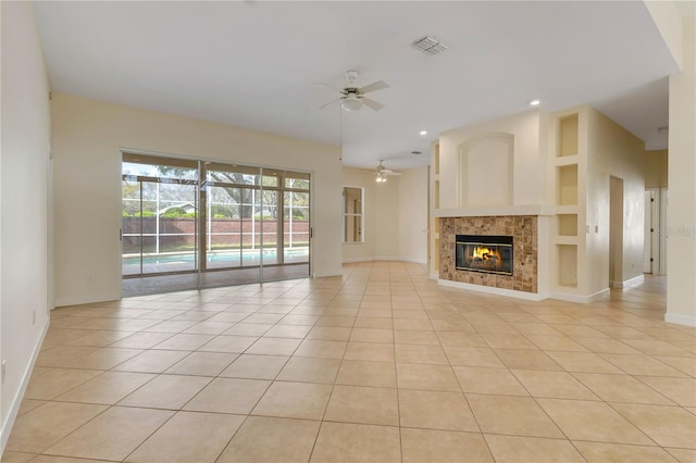 1187 Tadsworth Ter, Lake Mary, FL 32746 - unfurnished living room featuring visible vents, built in shelves, light tile patterned flooring, and a ceiling fan