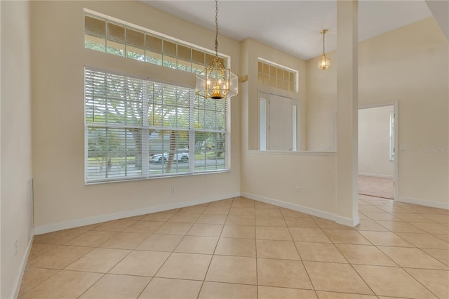 1187 Tadsworth Ter, Lake Mary, FL 32746 - empty room featuring baseboards, a towering ceiling, and tile patterned flooring