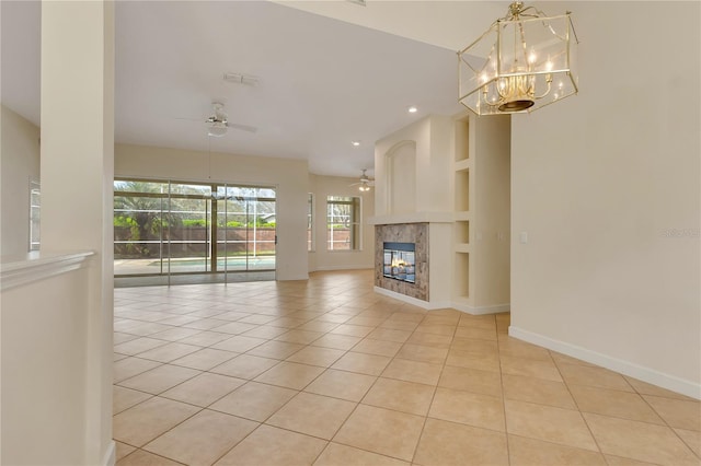 1187 Tadsworth Ter, Lake Mary, FL 32746 - unfurnished living room with baseboards, built in features, ceiling fan with notable chandelier, a fireplace, and light tile patterned flooring
