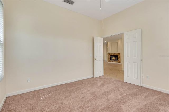 1187 Tadsworth Ter, Lake Mary, FL 32746 - carpeted spare room with a wealth of natural light, visible vents, a fireplace, and baseboards