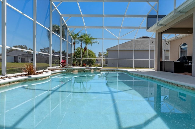 outdoor pool with a lanai and a patio area