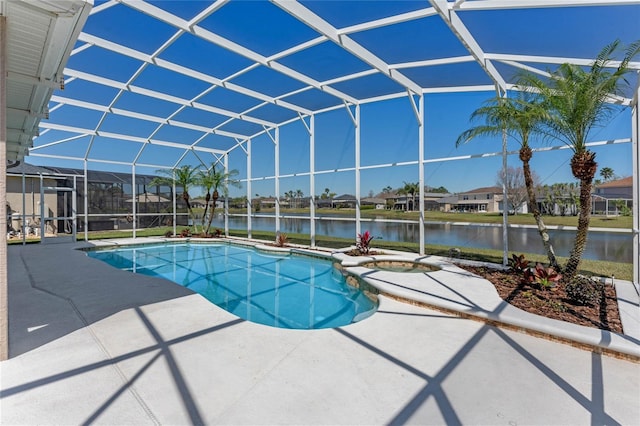 outdoor pool with glass enclosure, a patio, an in ground hot tub, and a water view