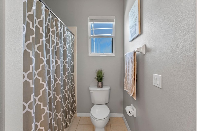 bathroom with curtained shower, baseboards, toilet, and tile patterned flooring