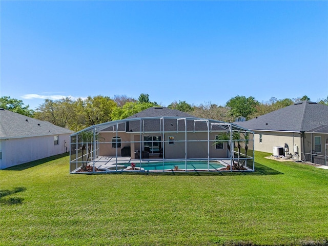 outdoor pool with a lanai, a patio area, central AC unit, and a yard