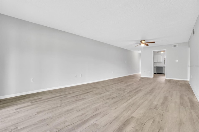 unfurnished living room with light wood finished floors, visible vents, baseboards, a textured ceiling, and a ceiling fan