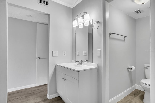 bathroom with visible vents, toilet, and wood finished floors