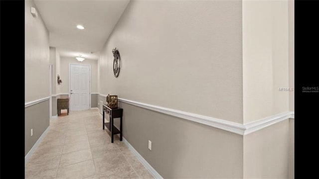 corridor featuring light tile patterned floors and recessed lighting