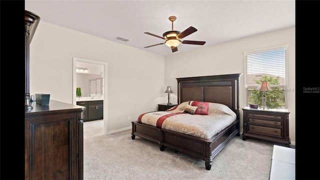 bedroom featuring visible vents, light carpet, a ceiling fan, connected bathroom, and baseboards