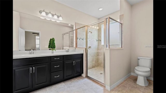 bathroom with a sink, double vanity, and a shower stall