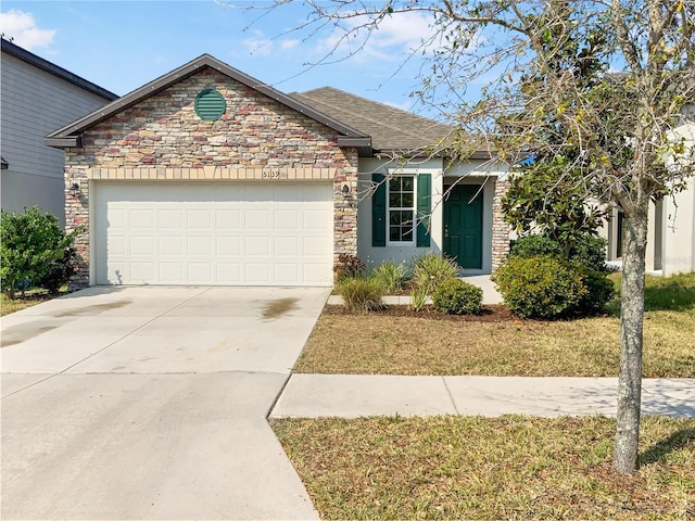 view of front facade with stone siding, driveway, roof with shingles, and an attached garage