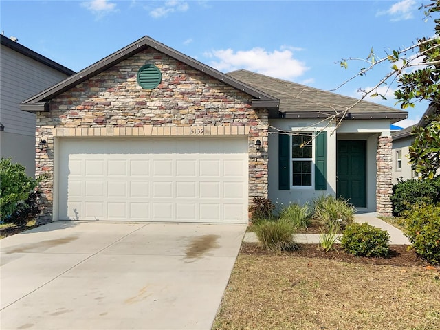 view of front of home featuring a garage, concrete driveway, and stucco siding