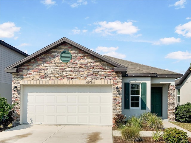 view of front of house with concrete driveway, a garage, roof with shingles, and stucco siding