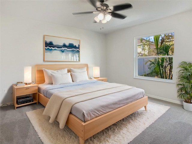 carpeted bedroom featuring a ceiling fan and baseboards