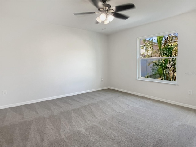 unfurnished room with carpet flooring, baseboards, and ceiling fan