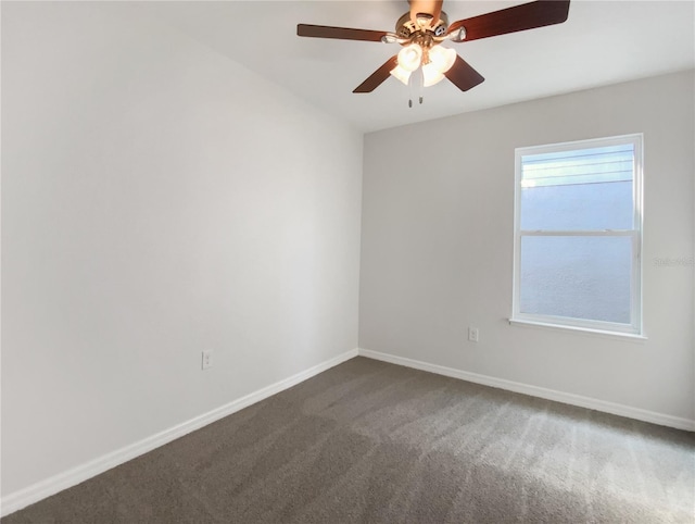 empty room with ceiling fan, baseboards, and dark colored carpet