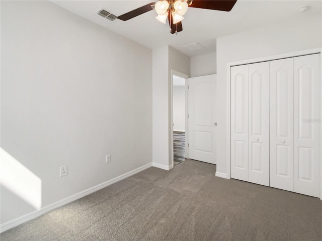 unfurnished bedroom with baseboards, visible vents, ceiling fan, a closet, and carpet flooring