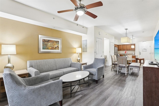 living room with dark wood finished floors, a ceiling fan, and electric panel