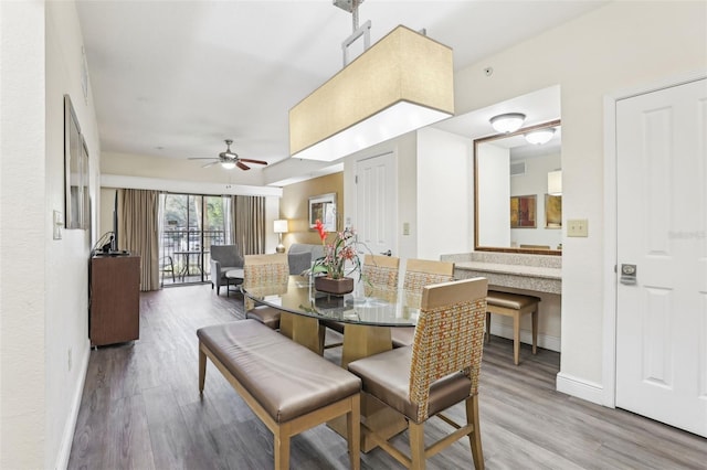 dining room with visible vents, baseboards, and wood finished floors